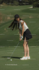 Woman Golfing on a Sunny Green Course