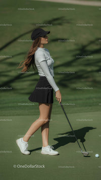 Young Female Golfer on a Sunny Day at the Course