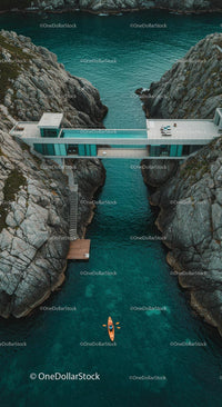 Luxury Cliffside Home with Kayakers on Turquoise Waters