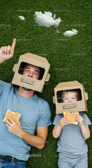 Father and Son with Cardboard Helmets Enjoying Outdoor Play