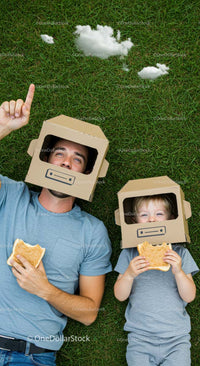 Father and Son with Cardboard Helmets Enjoying Outdoor Play