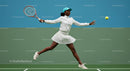Dynamic Female Tennis Player in Mid-Swing Action