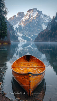 Wooden Boat on Serene Lake with Snow-Capped Mountain View