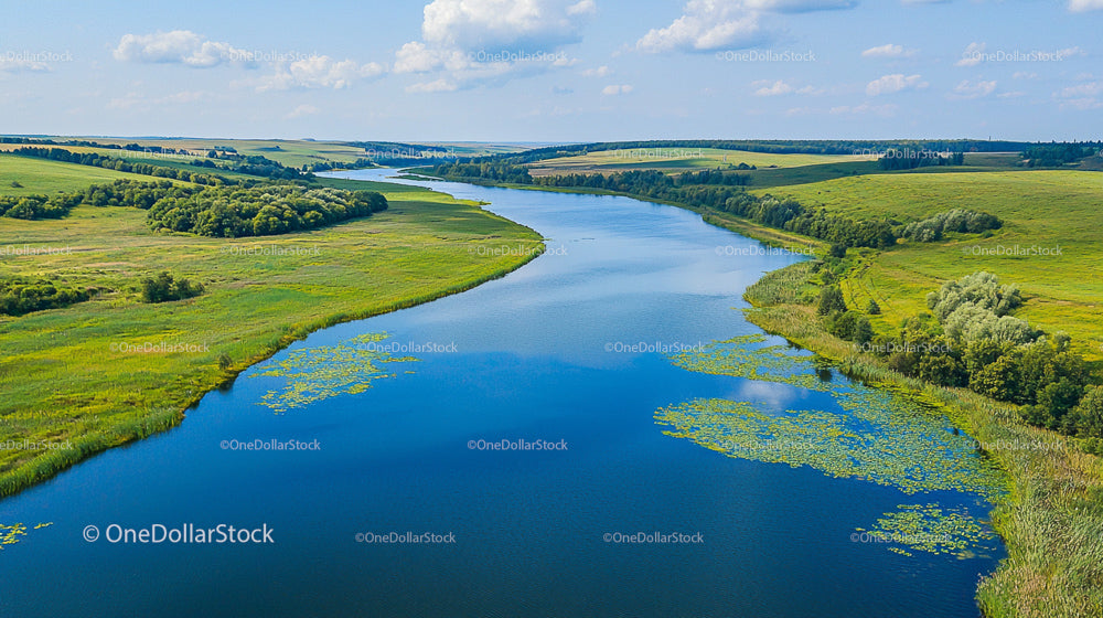 Aerial View of Meandering River Through Lush Countryside