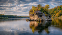 Rocky Island with Autumn Foliage on a Calm Lake