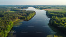 Aerial View of Serene River Flowing Through Lush Green Forest