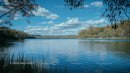 Tranquil Lake with Fluffy Clouds and Forested Hills
