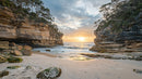 Sunrise Over Rugged Cliffs and Secluded Beach
