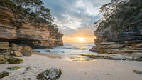 Sunrise Over Rugged Cliffs and Secluded Beach