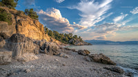 Rocky Coastal Landscape with Dramatic Clouds at Sunset