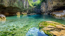 Tranquil Lagoon with Crystal Clear Water and Rocky Surroundings