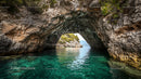 Turquoise Sea and Dramatic Rocky Archway in Coastal Landscape