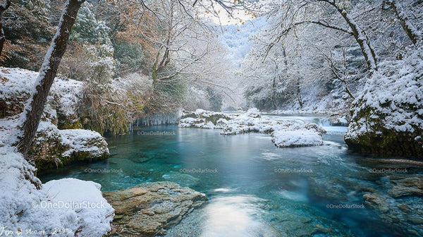 Serene Snowy River Flowing Through Winter Forest