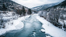 Scenic Winter River Flowing Through Snowy Mountain Landscape
