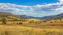 Wide Open Fields and Rolling Hills under Blue Skies