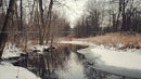 Serene Snowy River Flowing Through Winter Forest