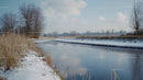 Frozen River and Snowy Landscape Under Clear Blue Sky