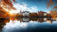 Scenic Autumn Cityscape with Reflective Lake and Colorful Trees