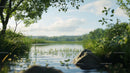 Tranquil Lake with Lush Greenery and Clear Blue Sky