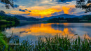 Stunning Sunset Over Tranquil Lake with Vibrant Reflections