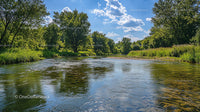 Scenic Summer River with Lush Greenery and Blue Sky