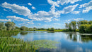 Tranquil Lake Under a Clear Blue Sky with Fluffy Clouds