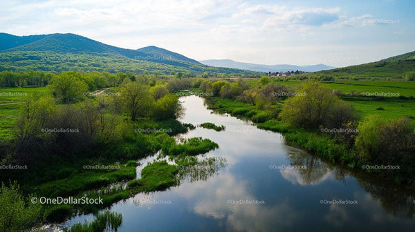 Lush Green Valley with Reflective River and Hills