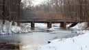Wooden Bridge Over Frozen River in Snowy Forest