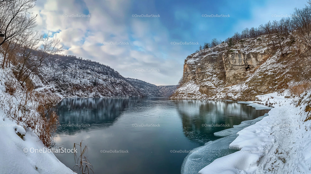 Snowy Cliffs and Icy River in Winter Serenity