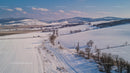 Aerial View of Snow-Covered Rolling Hills in Winter