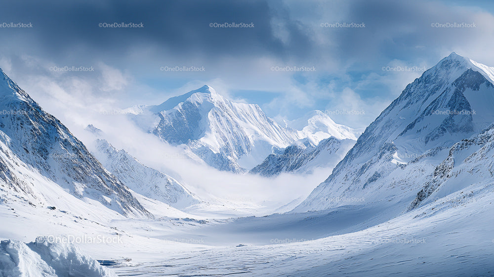 Majestic Snow-Capped Mountain Range Under Cloudy Sky