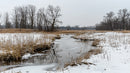 Frozen River Winding Through Winter Countryside