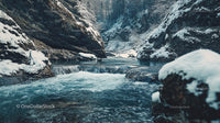 Serene Winter River Flowing Through Snowy Mountain Scenery