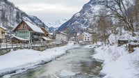 Snowy Alpine Village with Flowing Mountain Stream