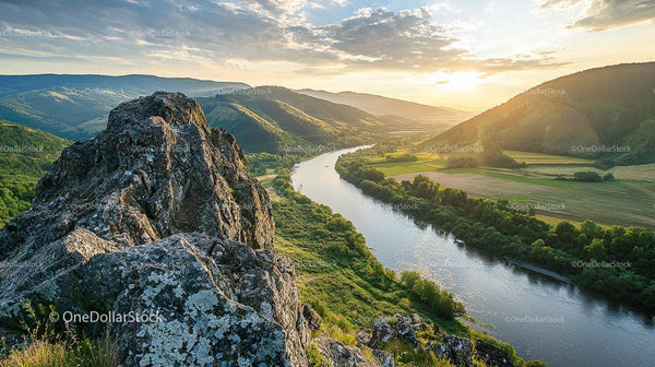 Sunset Over Serene River Valley and Rugged Mountain Peaks