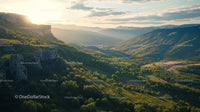 Sunset Over a Lush Green Valley with Majestic Mountains