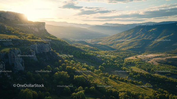 Sunset Over a Lush Green Valley with Majestic Mountains