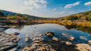 Tranquil River Scene with Rocky Bank and Reflective Waters