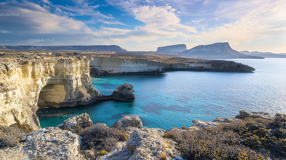 Rocky Coastal Cliffs and Azure Waters Under a Blue Sky