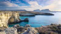 Rocky Coastal Cliffs and Azure Waters Under a Blue Sky