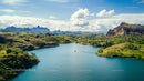 Scenic Lake Amid Lush Green Hills and Majestic Mountains