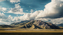 Dramatic Mountain Range Under Expansive Clouded Sky