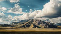 Dramatic Mountain Range Under Expansive Clouded Sky