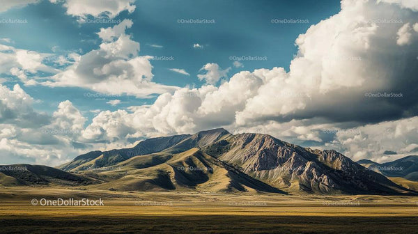 Dramatic Mountain Range Under Expansive Clouded Sky