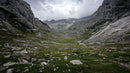 Majestic Mountain Valley with Dramatic Sky and Rugged Terrain