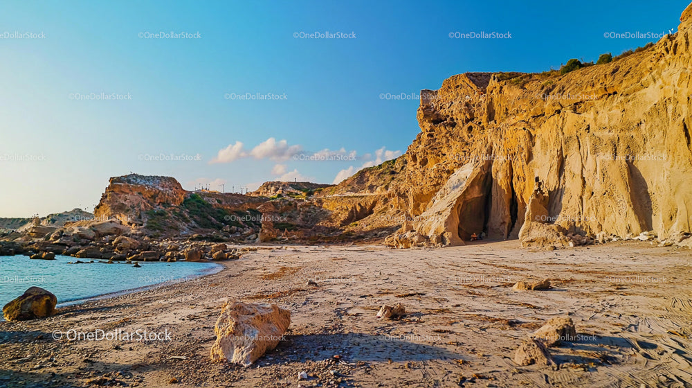 Serene Seaside Cliffs and Sandy Beach at Sunset