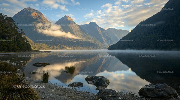Misty Morning Reflection in Tranquil Mountain Lake