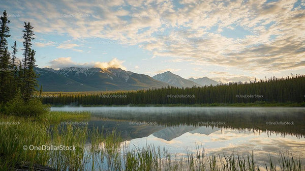 Serene Mountain Lake with Morning Mist and Reflections