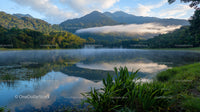 Misty Lake with Mountain Reflections in Tranquil Landscape