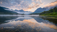 Tranquil Morning Mist Over Majestic Mountain Lake